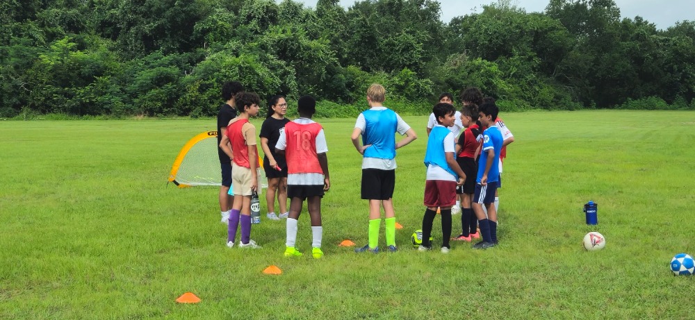 ISA players and coach in a team huddle